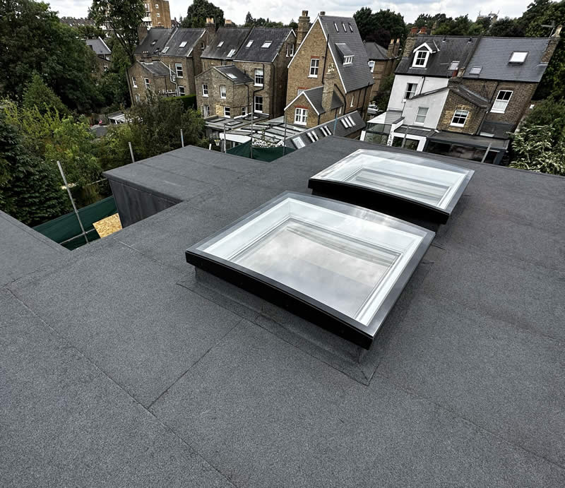 Velux roof windows on a flat roof, enhancing natural light and energy efficiency in a residential setting.